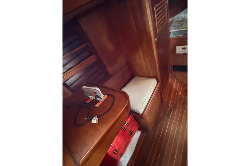 Slide: The Image of Interior of 1985 Shannon Ketch sailboat with wooden paneling and seating area. - 9