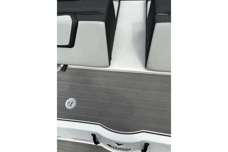 Slide: The Image of 2023 Yamaha Boats AR250 interior with sleek seating and modern flooring design. - 27