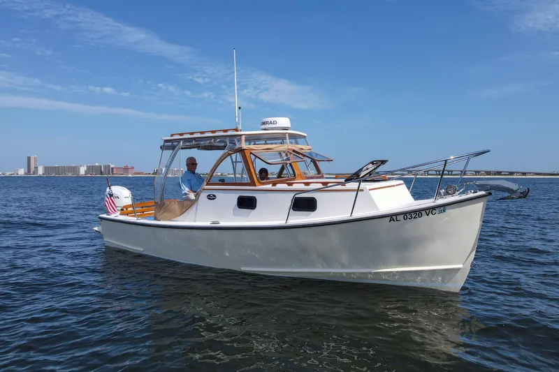 Slide: The Image of 2019 Seaway Seafarer 24 boat cruising on calm waters under a clear blue sky. - 31