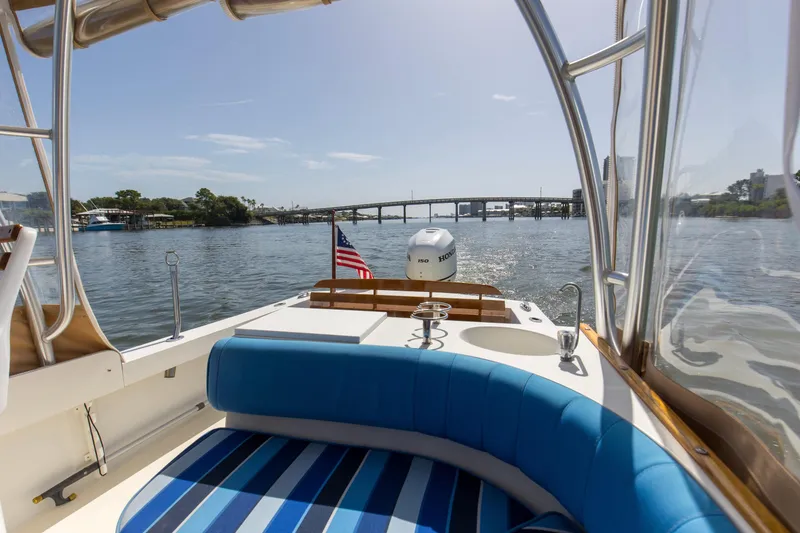 Slide: The Image of 2019 Seaway Seafarer 24 boat interior with blue seating, cruising on a sunny day. - 15