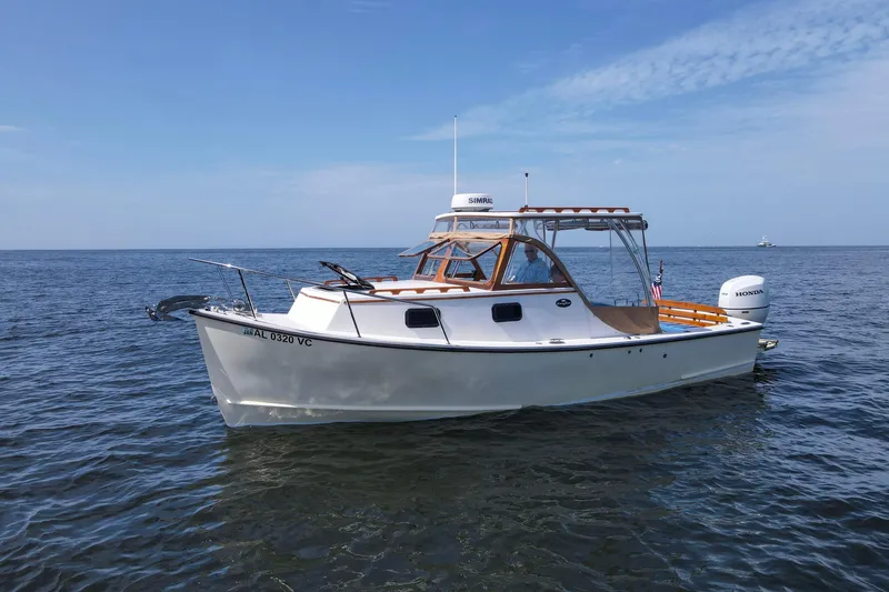 Slide: The Image of 2019 Seaway Seafarer 24 boat on calm ocean waters under clear blue sky. - 29