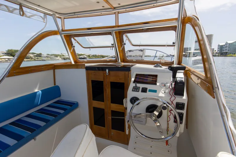 Slide: The Image of 2019 Seaway Seafarer 24 boat interior with steering wheel and control panel. - 24