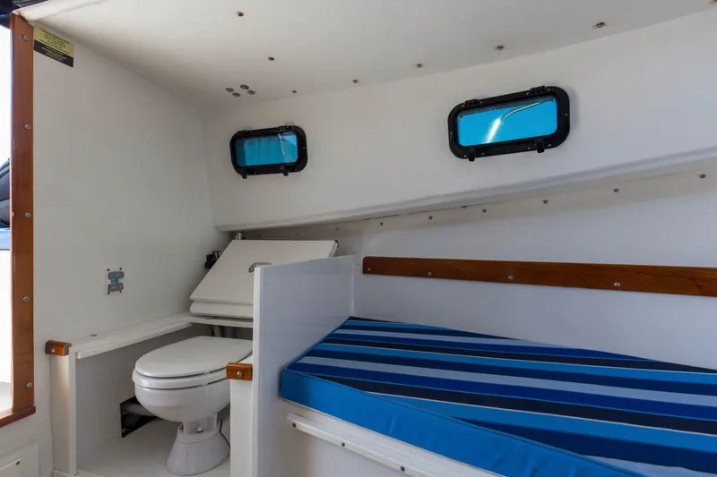 Slide: The Image of Interior of 2019 Seaway Seafarer 24 boat with toilet and striped cushion. - 12