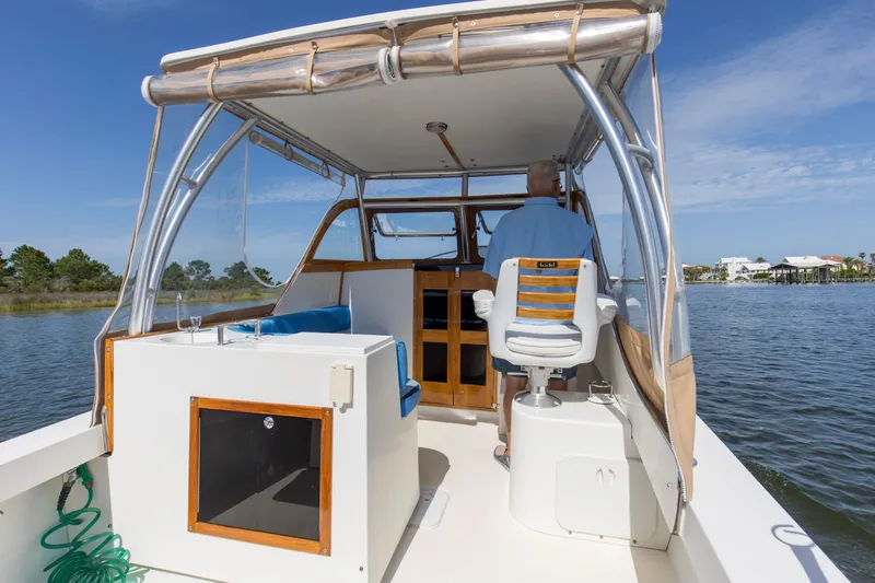Slide: The Image of 2019 Seaway Seafarer 24 boat interior with helm, seating, and water view. - 14
