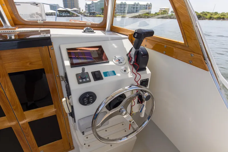 Slide: The Image of Helm of 2019 Seaway Seafarer 24 boat with steering wheel and control panel. - 26