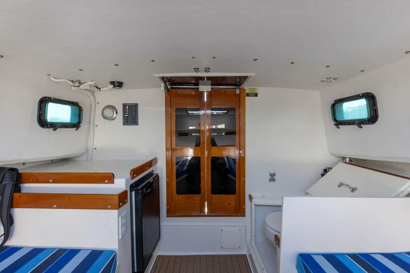 Slide: The Image of Interior of 2019 Seaway Seafarer 24 boat with wooden accents and compact amenities. - 13