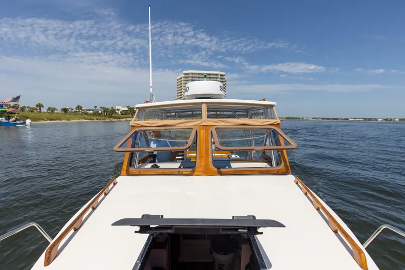 Slide: The Image of 2019 Seaway Seafarer 24 boat cruising on a sunny day near the shoreline. - 22