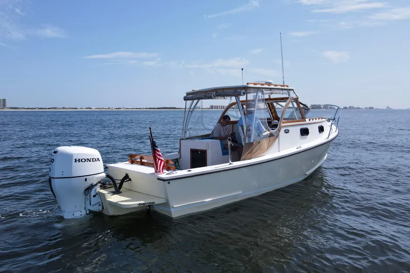 Slide: The Image of 2019 Seaway Seafarer 24 boat cruising on open water with Honda outboard motor. - 32