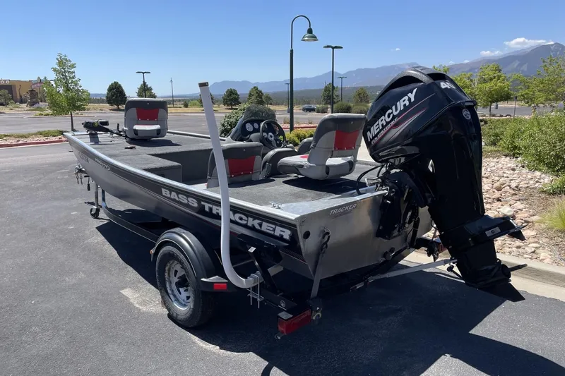 Slide: The Image of 2015 Tracker Pro 170 bass boat with Mercury engine in a parking lot. - 4