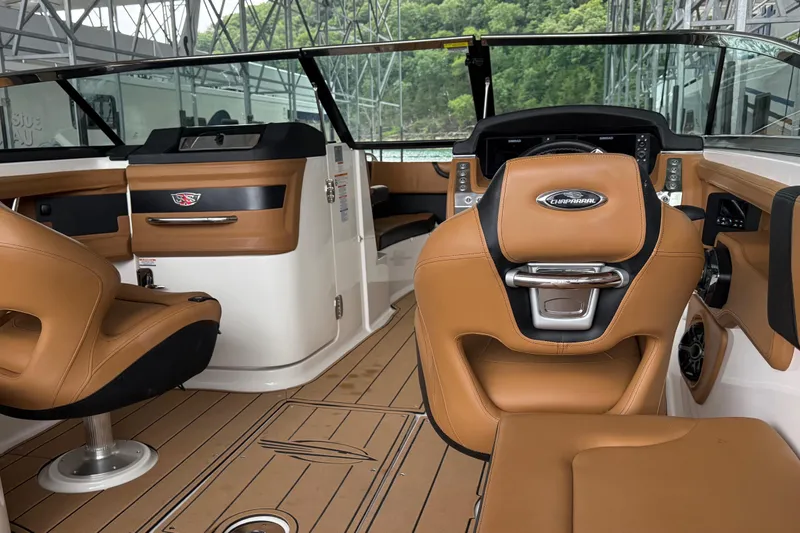 Slide: The Image of 2023 Chaparral 287 SSX boat interior with tan leather seats and modern dashboard. - 3