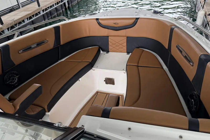 Slide: The Image of 2023 Chaparral 287 SSX boat interior with luxurious brown and black seating. - 6