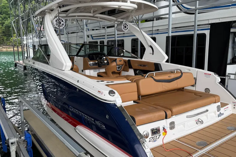The Image of 2023 Chaparral 287 SSX boat docked, featuring luxurious tan seating and sleek design. - 0