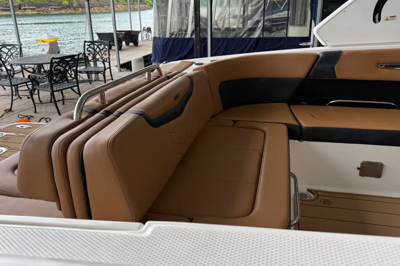 Slide: The Image of 2023 Chaparral 287 SSX boat interior with tan leather seating and sleek design. - 10