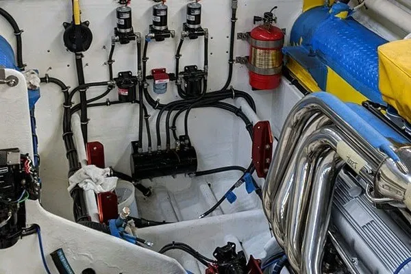 Slide: The Image of Engine compartment of a 1987 Apache 47 boat with visible wiring and exhaust system. - 9