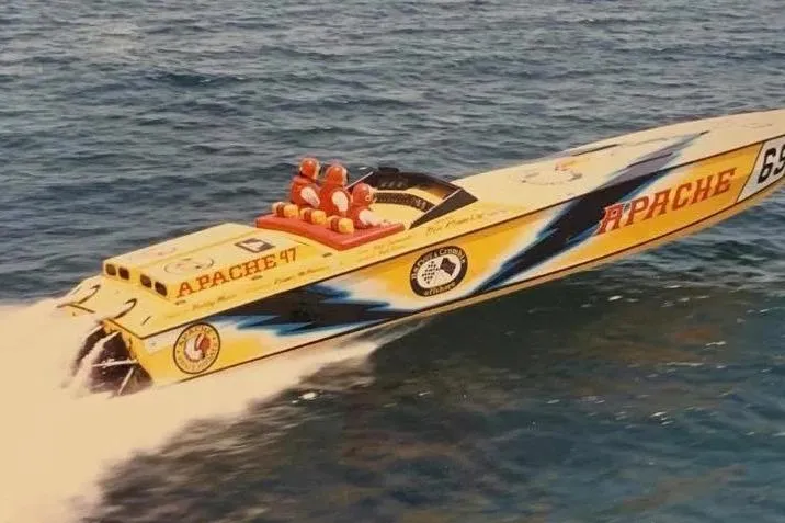 The Image of High-speed Apache 47 powerboat from 1987 racing on open water. - 1