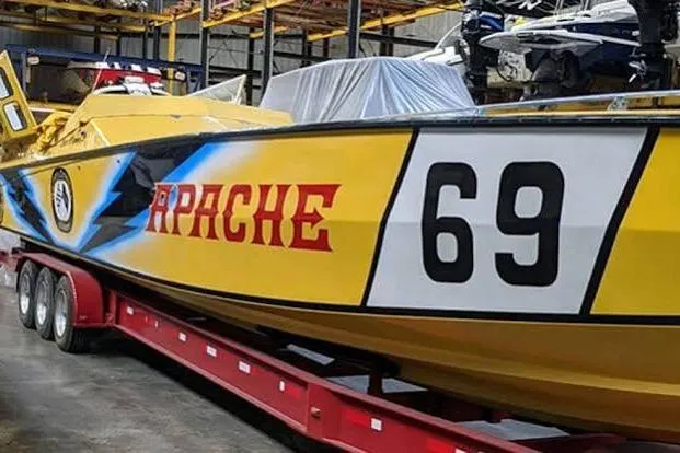 Slide: The Image of Yellow 1987 Apache 47 speedboat with "Apache 69" on the side, displayed on a red trailer. - 18