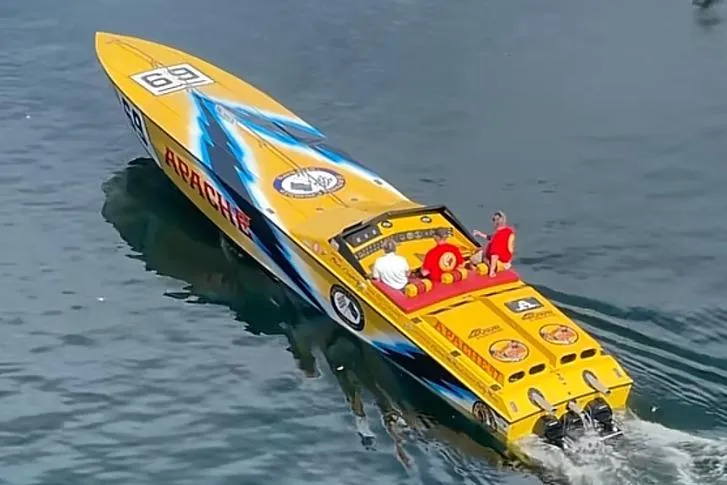 Slide: The Image of Yellow 1987 Apache 47 speedboat with blue accents on water, featuring three passengers. - 5