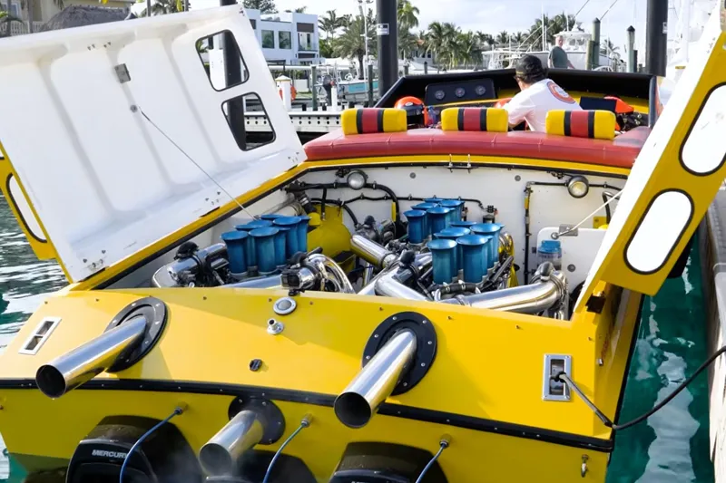 Slide: The Image of Yellow 1987 Apache 47 boat with open engine compartment, docked at marina. - 11