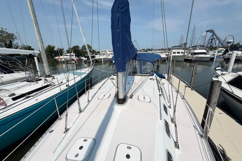 Slide: The Image of 1995 Catalina 400 sailboat docked in a marina, surrounded by other boats. - 17
