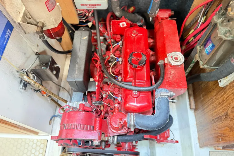 Slide: The Image of Red engine inside a 1995 Catalina 400 sailboat, showcasing mechanical components and wiring. - 41