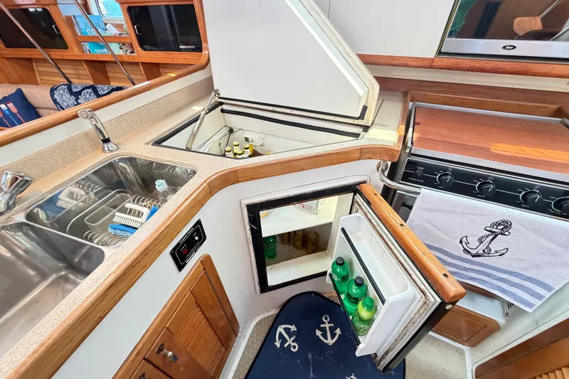Slide: The Image of Galley of a 1995 Catalina 400 sailboat with sink, stove, and fridge. - 24