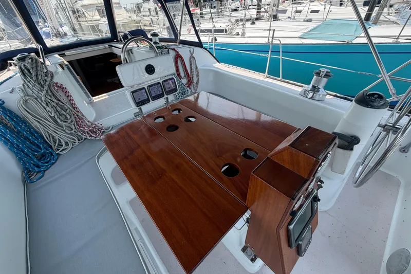 Slide: The Image of Cockpit of a 1995 Catalina 400 sailboat with wooden table and navigation instruments. - 11
