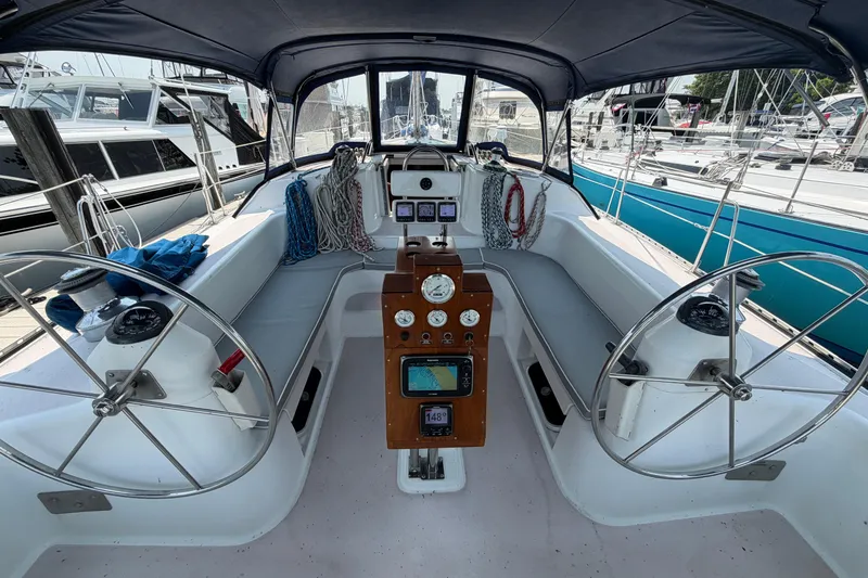 Slide: The Image of Cockpit of a 1995 Catalina 400 sailboat with dual steering wheels and navigation instruments. - 6