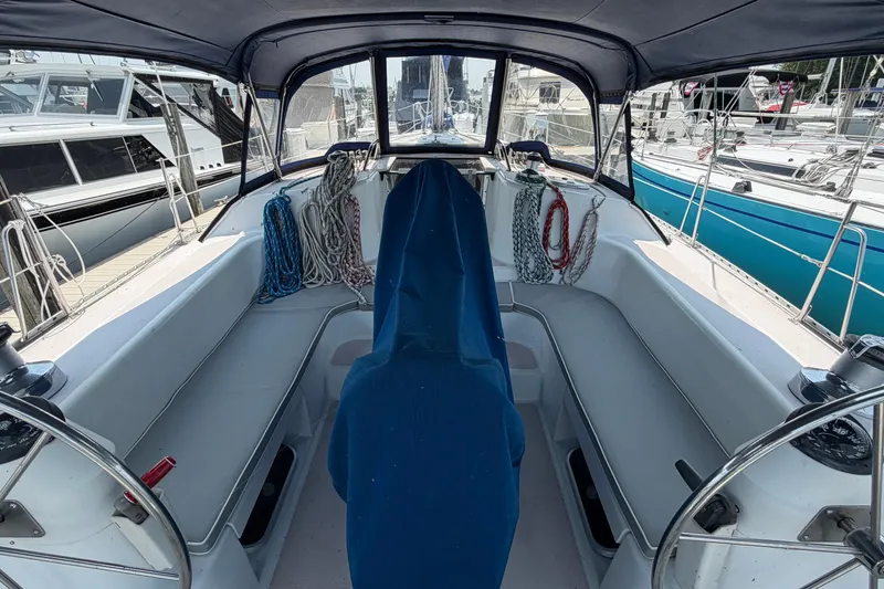 Slide: The Image of Cockpit of a 1995 Catalina 400 sailboat, featuring seating and coiled ropes. - 45