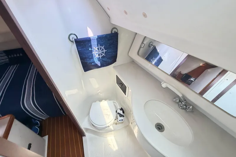 Slide: The Image of Bathroom interior of a 1995 Catalina 400 yacht, featuring a sink and toilet. - 37