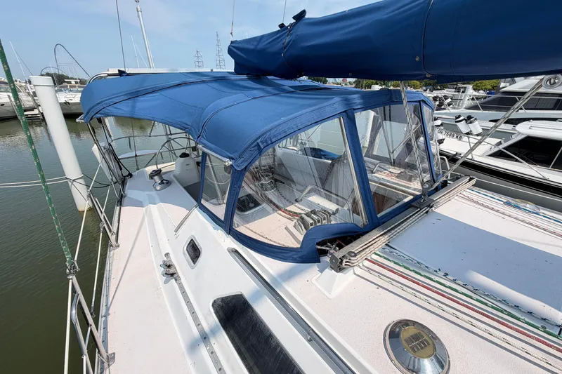 Slide: The Image of Sailboat Catalina 400, 1995 model, with blue canopy docked at marina. - 19