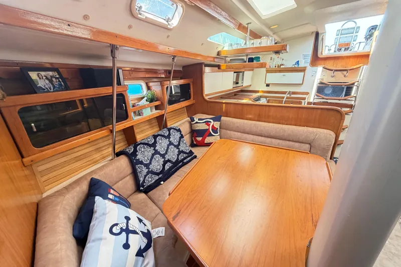 Slide: The Image of Interior of a 1995 Catalina 400 sailboat with cozy seating and wooden finishes. - 29