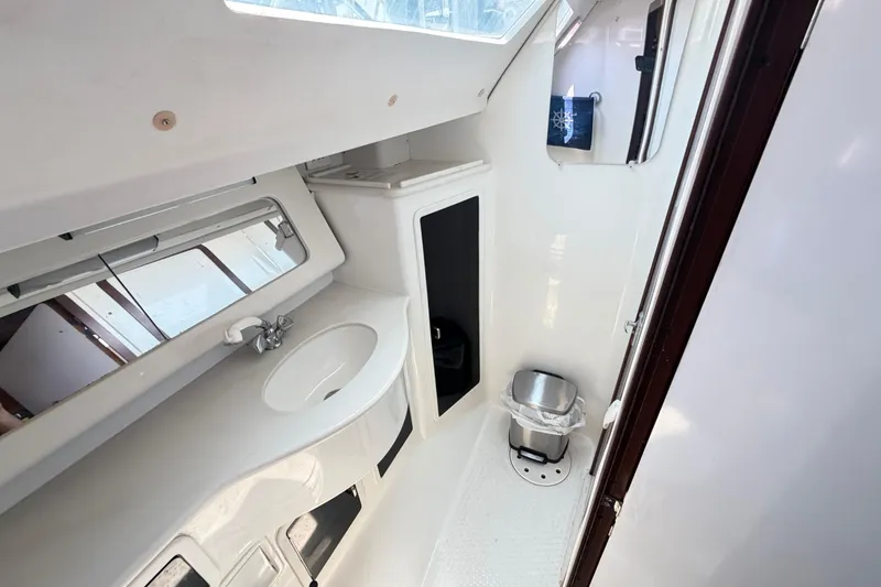 Slide: The Image of Interior of a 1995 Catalina 400 yacht bathroom with sink and mirror. - 38