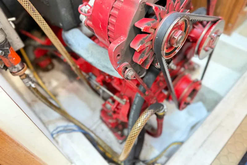 Slide: The Image of Engine compartment of a 1995 Catalina 400 sailboat, featuring red mechanical components. - 42