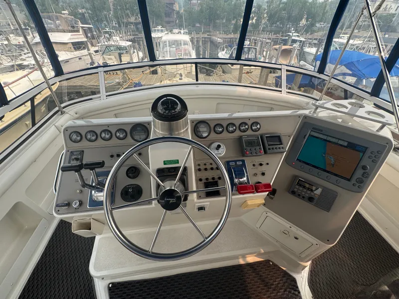 Slide: The Image of The image shows the helm of a 1997 Carver 445 Aft Cabin Motor Yacht with modern instruments. - 3