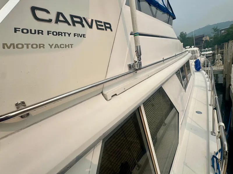 Slide: The Image of The 1997 Carver 445 Aft Cabin Motor Yacht is docked, showcasing its sleek design. - 17