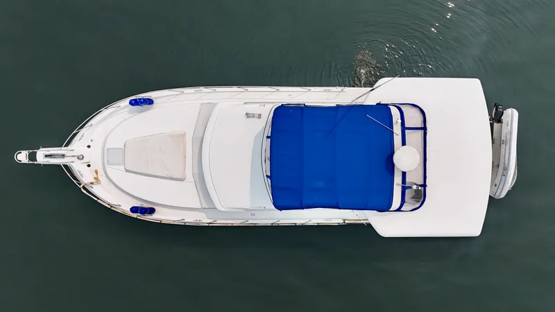 Slide: The Image of Aerial view of a 1997 Carver 445 Aft Cabin Motor Yacht with a blue sunshade. - 14