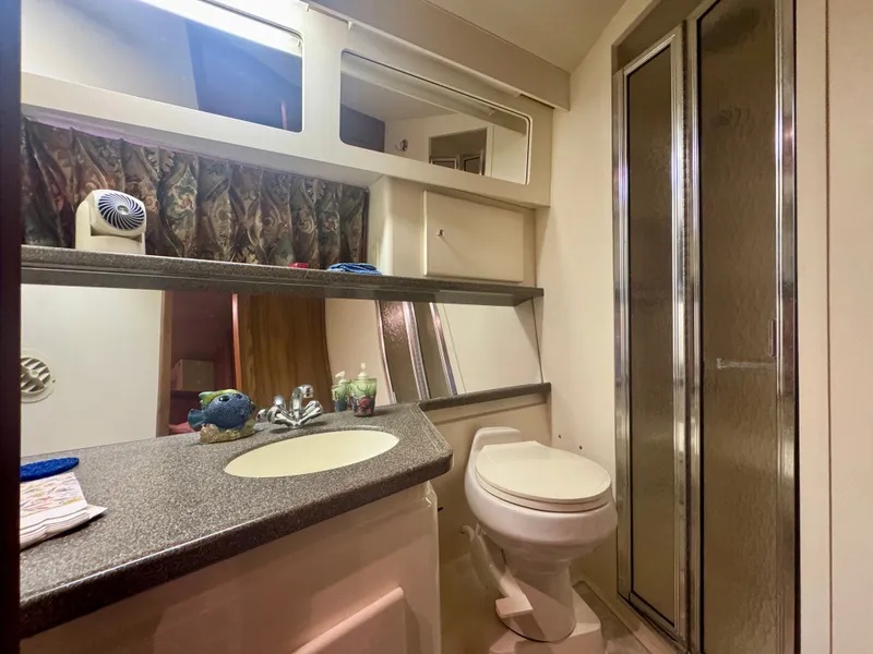 Slide: The Image of The image shows a yacht bathroom with a sink, toilet, and shower. - 41