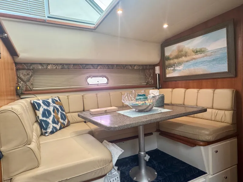 Slide: The Image of Interior of the 1997 Carver 445 Aft Cabin Motor Yacht with cozy seating and artwork. - 36