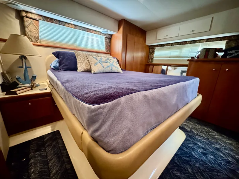 Slide: The Image of The image shows a cozy cabin with a double bed, decorative pillows, and wooden furnishings. - 46