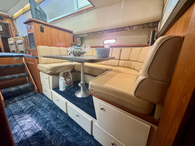 Slide: The Image of Interior of a 1997 Carver 445 Aft Cabin Motor Yacht with beige sofa and table. - 39