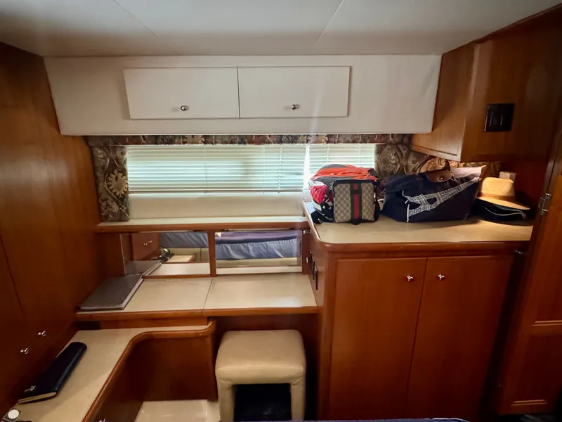 Slide: The Image of Interior of a 1997 Carver 445 Aft Cabin Motor Yacht with wooden cabinetry and storage space. - 47