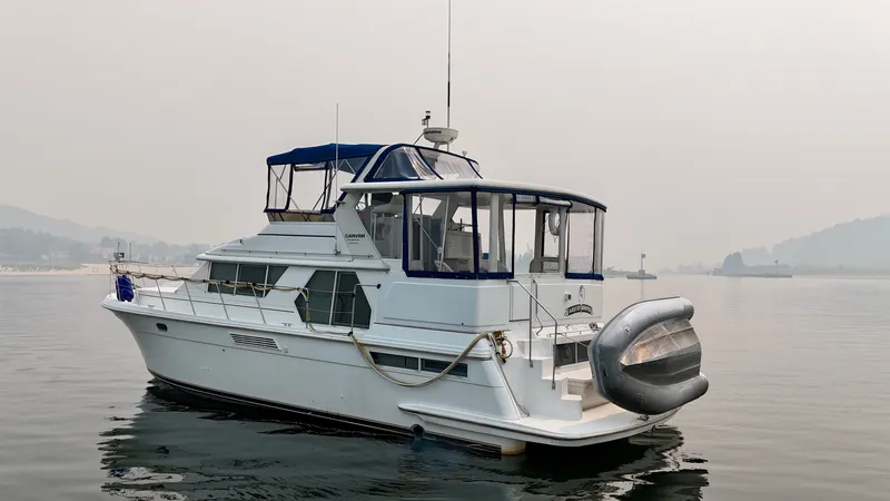 Slide: The Image of A 1997 Carver 445 Aft Cabin Motor Yacht sits calmly on the water. - 10