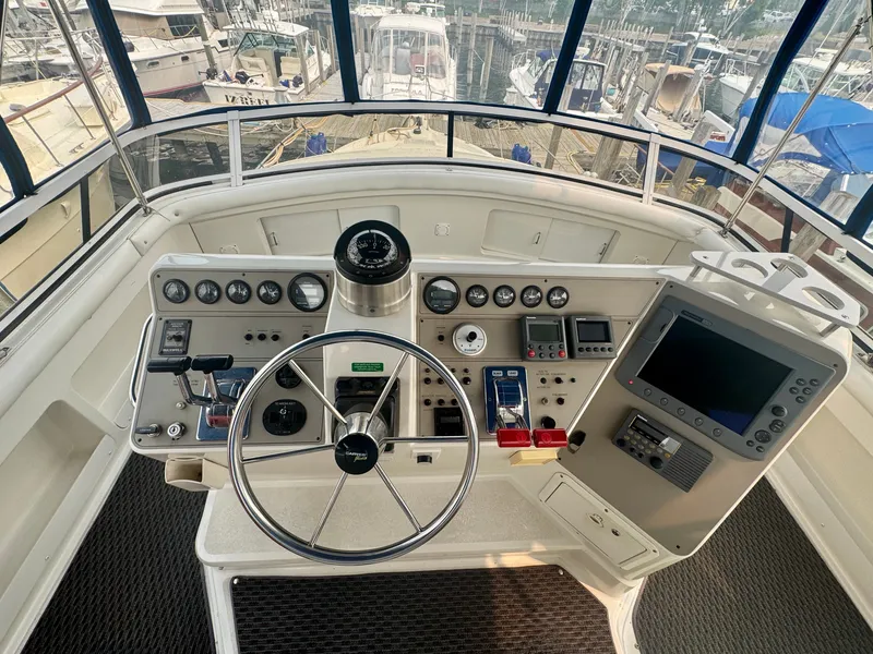 Slide: The Image of The cockpit of a 1997 Carver 445 Aft Cabin Motor Yacht with steering wheel and instruments. - 25