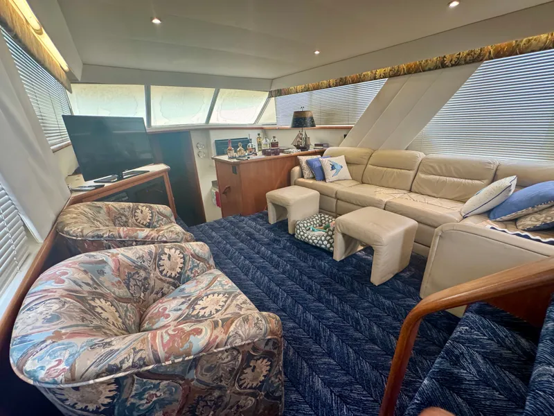 Slide: The Image of Interior of a 1997 Carver 445 Aft Cabin Motor Yacht with cozy seating and a TV. - 32