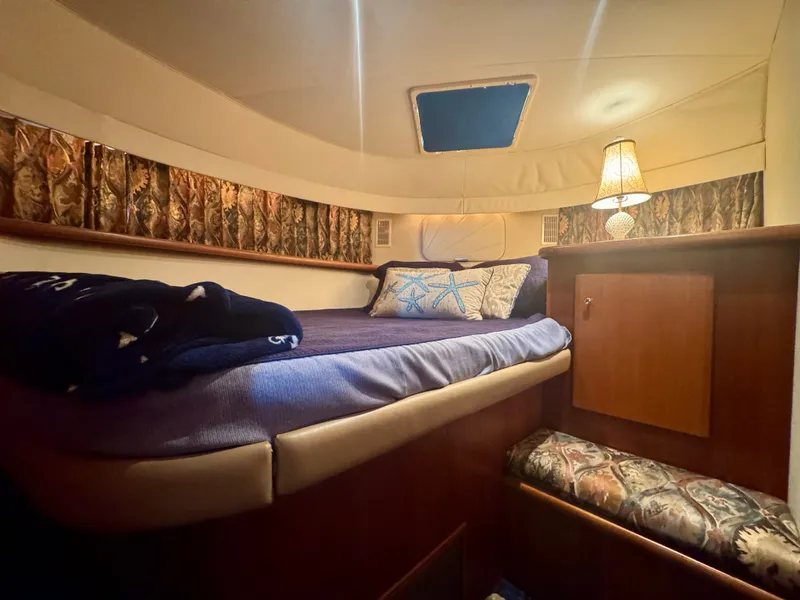 Slide: The Image of Cozy cabin with a double bed, decorative pillows, and a lamp, surrounded by wooden furnishings. - 40