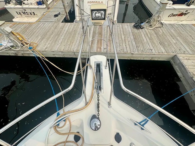 Slide: The Image of Bow view of a 1997 Carver 445 Aft Cabin Motor Yacht docked at a wooden pier. - 18