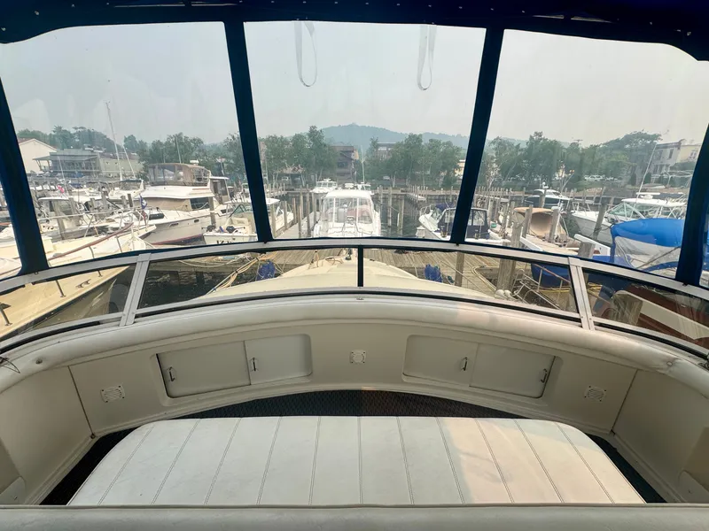 Slide: The Image of 1997 Carver 445 Aft Cabin Motor Yacht in a marina, featuring a spacious deck and surrounding boats. - 28