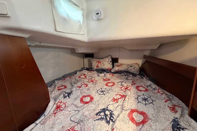 Slide: The Image of Cozy cabin interior of 2006 Beneteau 423 sailboat with nautical-themed bedding. - 44