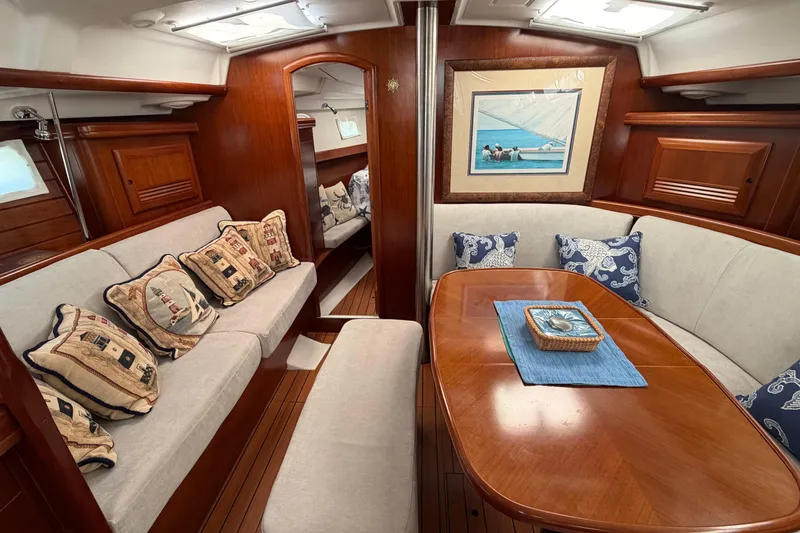Slide: The Image of Interior of 2006 Beneteau 423 yacht with elegant wood finish and nautical-themed cushions. - 40