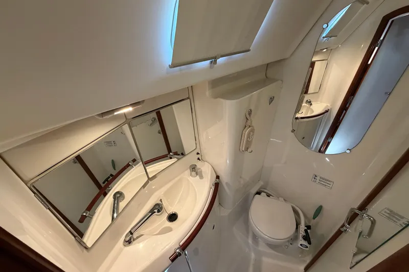 Slide: The Image of Bathroom interior of a 2006 Beneteau 423 yacht, featuring sink, mirror, and toilet. - 45